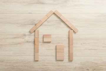 Real estate concept with a wood block outline of a house