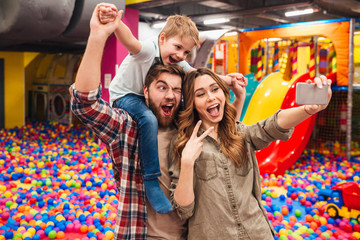 Cheerful little child have fun with his parents