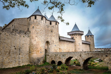 Fototapeta na wymiar Castle walls of Carcassonne fortress in France with crowd clouds on the background