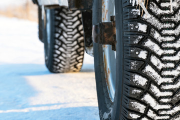 Studded winter car tires on winter road