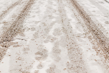 roadway covered with  snow and  wheels traces