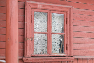 small window in  wall of old wooden house