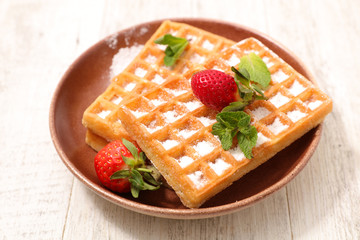 waffles with sugar and strawberry