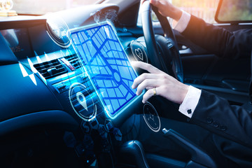 The abstract image of businessman point to the navigation hologram in car cockpit. the concept of...