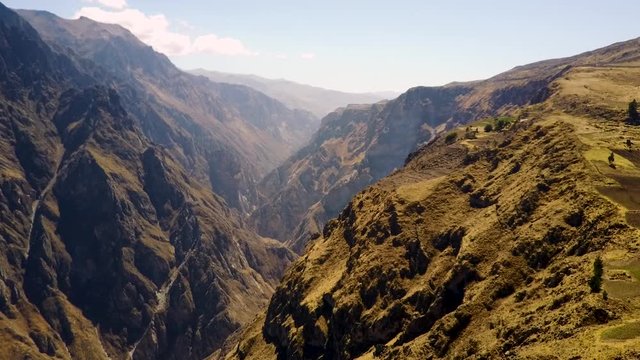 Stunning aerial view flying backwards over the Colca Canyon in the Peruvian Andes Mountains