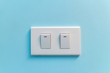white light switch against blue wall