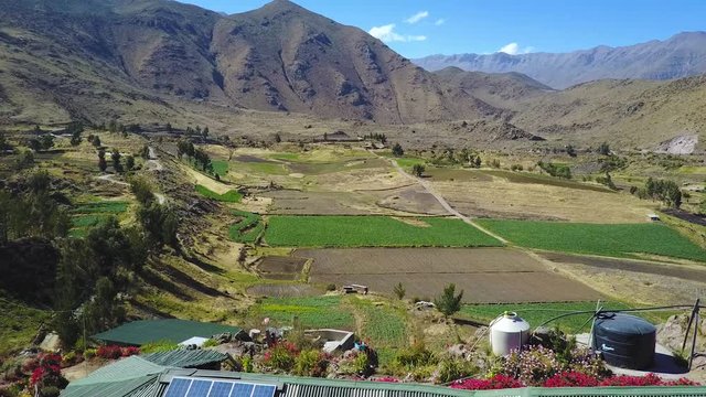 A beautiful home overlooks the Colca Canyon, view from a drone flying over the canyon in Peru