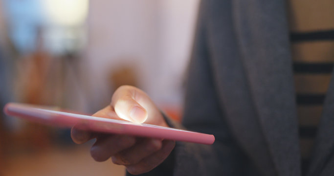 Woman using cellphone to pay the bill