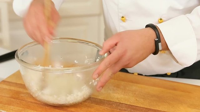 Mixing boiled rice in a glass bowl