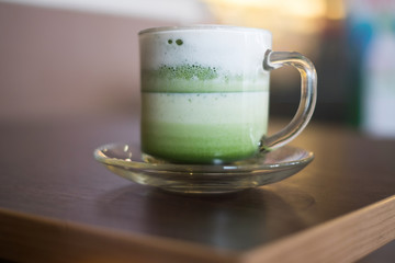 hot latte art on wooden table blur background