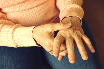 Close up of mature womans hands. Health care giving, nursing home. Parental love of grandmother....