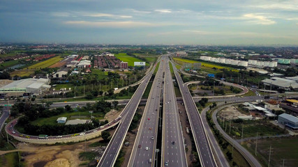 Aerial view of an intersection of a highway at the moment of sunset evening.