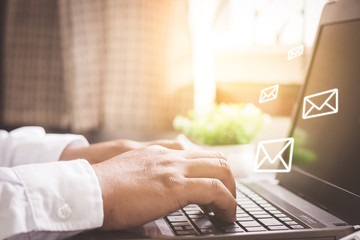 Man hand using Laptop with email icon.