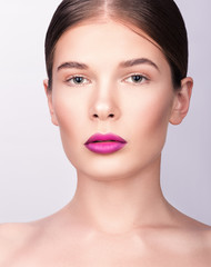 Obraz premium Beauty closeup portrait. Beautiful young woman with bright professional make-up. The hair is collected