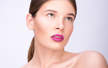 Beauty portrait of a beautiful young woman. Bright lips and professional make-up. Clean fresh skin