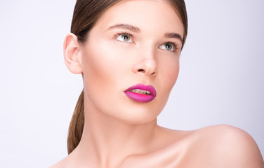 Obraz premium Beauty portrait of a beautiful young woman. Bright lips and professional make-up. Clean fresh skin
