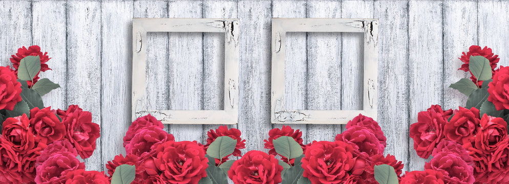 Banner with roses and two empty photo frames on background of shabby wooden planks in rustic style