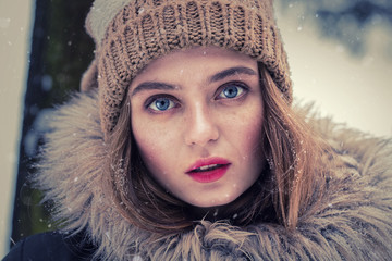 Portrait of a beautiful girl dressed for winter. Beautiful features, nice face
