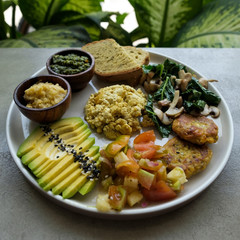 Vegan tofu with avocado, bread, vegetables and source close-up on a plate. Concept of eco healthy diet