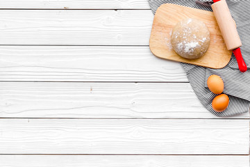 Make dough. Ingedients flour, eggs near cookware on white wooden background top view copy space