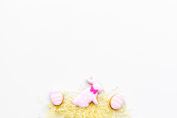 Sweets, pastry for Easter table. Easter eggs and Easter bunny concept. White background top view space for text