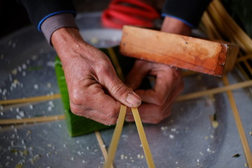 Packing Banh Chung (sticky rice cake), this is a traditional Vietnamese rice cake which is made from glutinous rice, mung beans, pork and other ingredients.