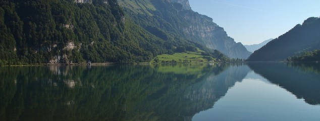 Fototapeta na wymiar Summer scene at lake Klontalersee, Glarus Canton. Swiss Alps. Reflection.
