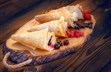 Pancakes stuffed with freshly-frozen berries of raspberry, strawberry, honeysuckle and black...