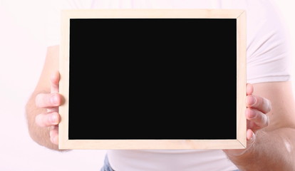 Small free space blackboard in the hands on white backgrounds.