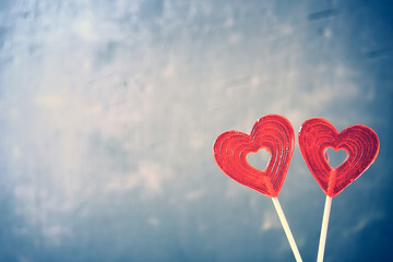 Fototapeta na wymiar Two sweet valentines hearts on blue abstract background.