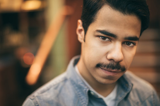 Portrait On Young Arabic Mustache Man Looking To The Camera