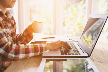 woman working with laptop and drinking coffee