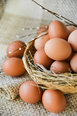 fresh farm chicken egg in the basket on textile background, preparation for Easter