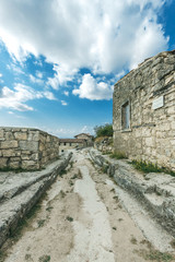 Fototapeta premium Ruins of old architecture outdoor in the east of the Crimea. The historical sites and famous monuments, the buildings of the Tatars in the city of Bakhchisaray. Traveling through medieval culture