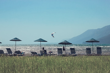 Kite surfing on a background of green Turkish mountains. popular sea sport. Beautiful sea sports landscape