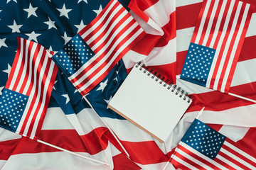 top view of arranged american flags and blank notebook, presidents day concept