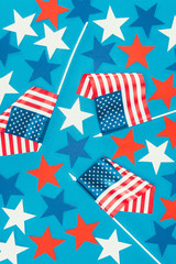 Obraz premium top view of arranged stars and american flags isolated on blue, presidents day celebration concept
