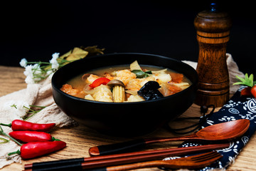 Bowls of Asian soup noodles and seafood with Chopstick