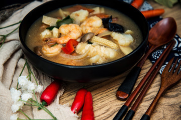 Bowls of Asian soup noodles and seafood with Chopstick