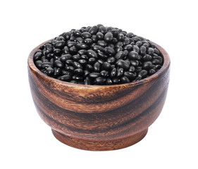 Black beans in wooden bowl isolated on white background