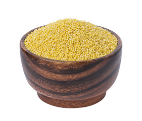 Millet groats in wooden bowl isolated on white background