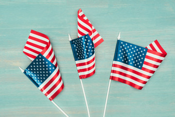 top view of arranged american flags on blue wooden surface, presidents day concept