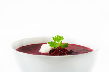 Beet soup in white bowl isolated on white background

