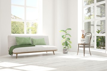 Fototapeta premium Idea of white room with sofa and summer landscape in window. Scandinavian interior design. 3D illustration