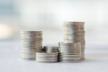 Money and Business Concpet. Stack of silver coins on notebook.