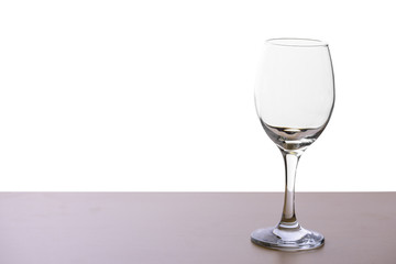 Glass of wine on the wooden table in white background or isolated