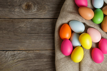 Painted Easter eggs on sackcloth, rustic festive composition