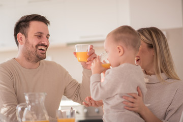 Happy parents and son in kitchen