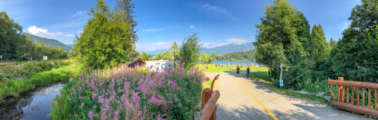 WHISTLER, CANADA - AUGUST 12, 2017: Tourists enjoy Rainbow Park Lake. Whistler is a famous winter skiing destination in Canada