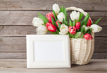 Fresh tulip flowers bouquet and photo frame